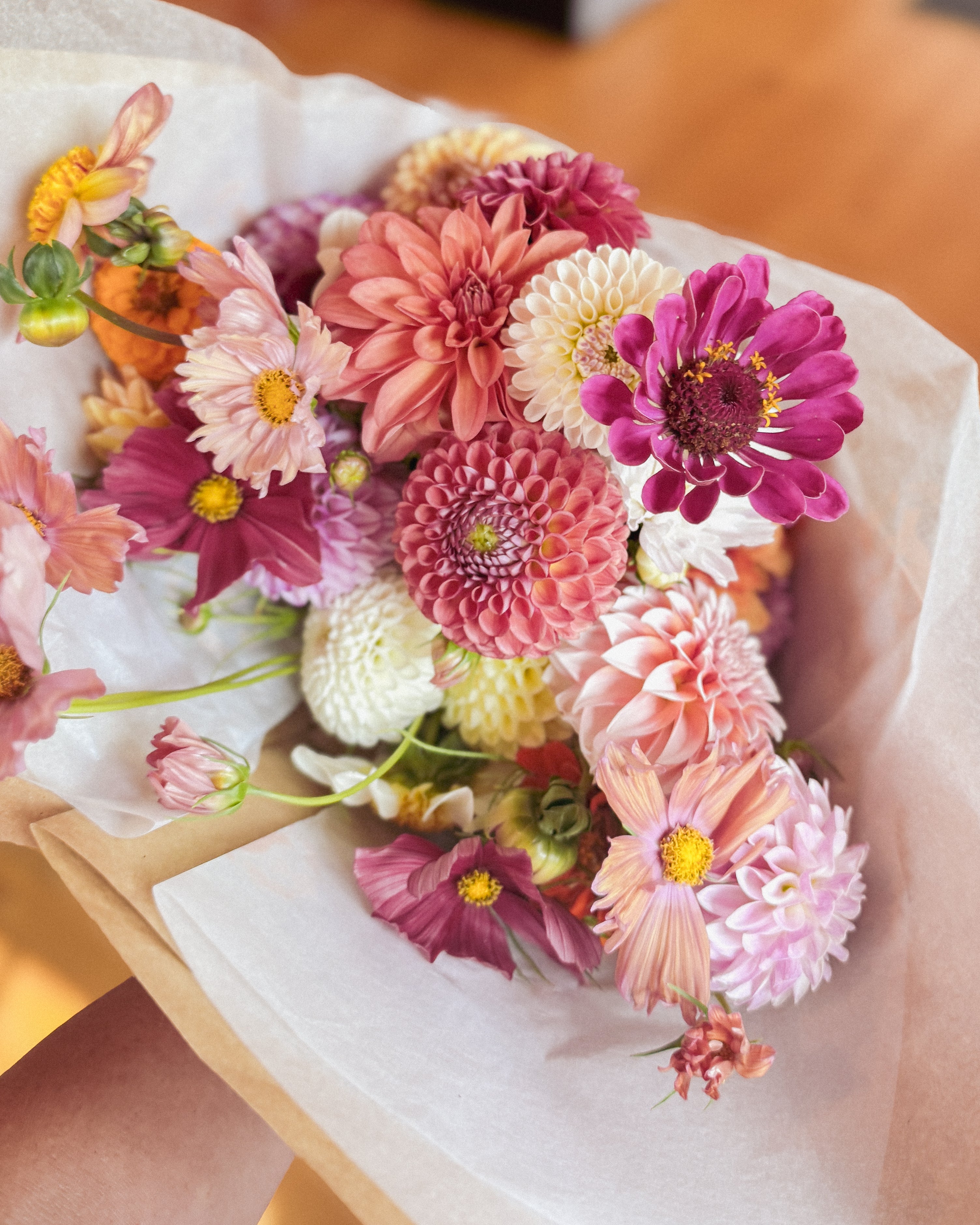 Wrapping a hand-tied bouquet at a Floral Fridays workshop