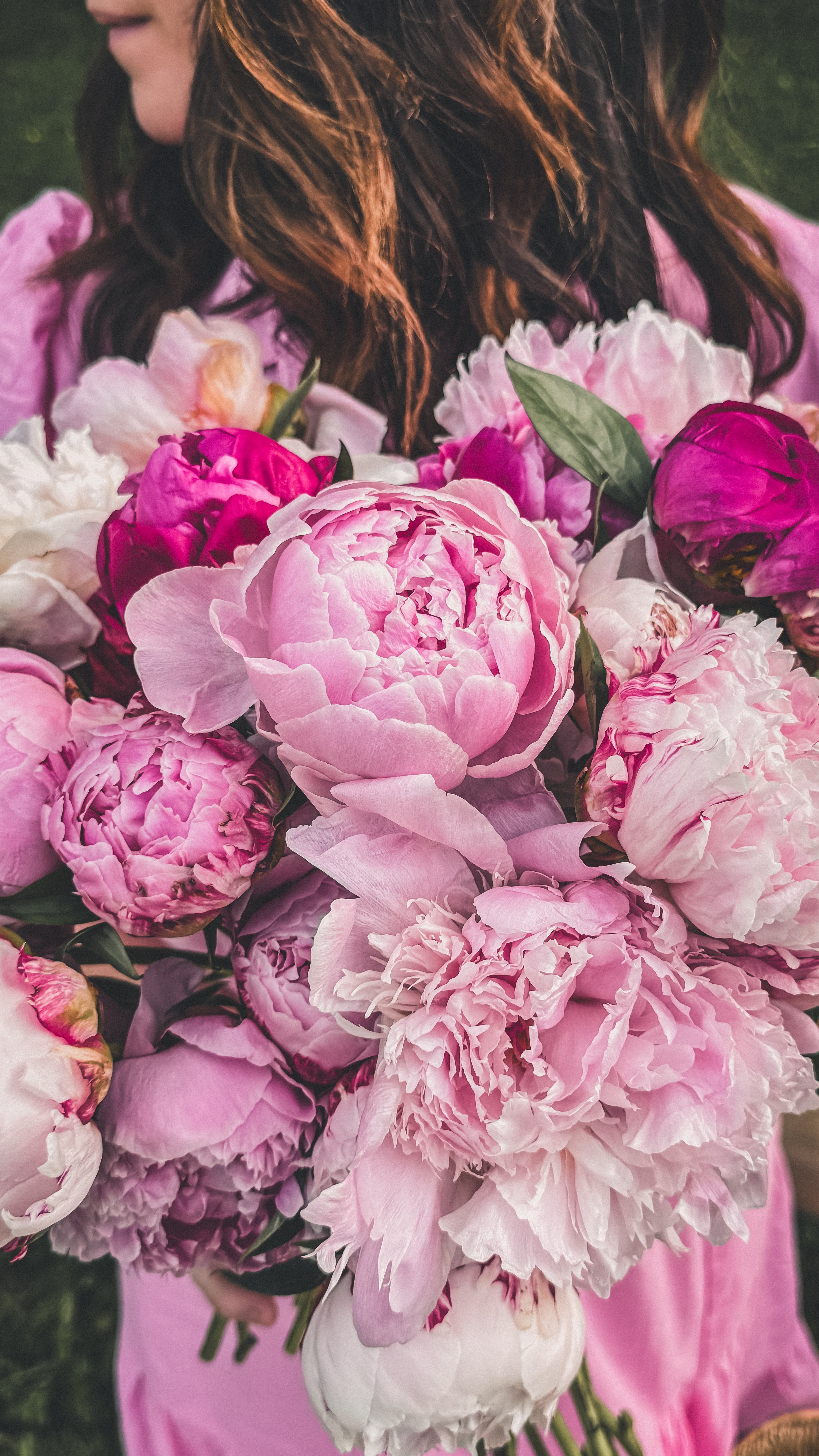 Close-up of a bouquet of pink and white peonies with a blurred background
