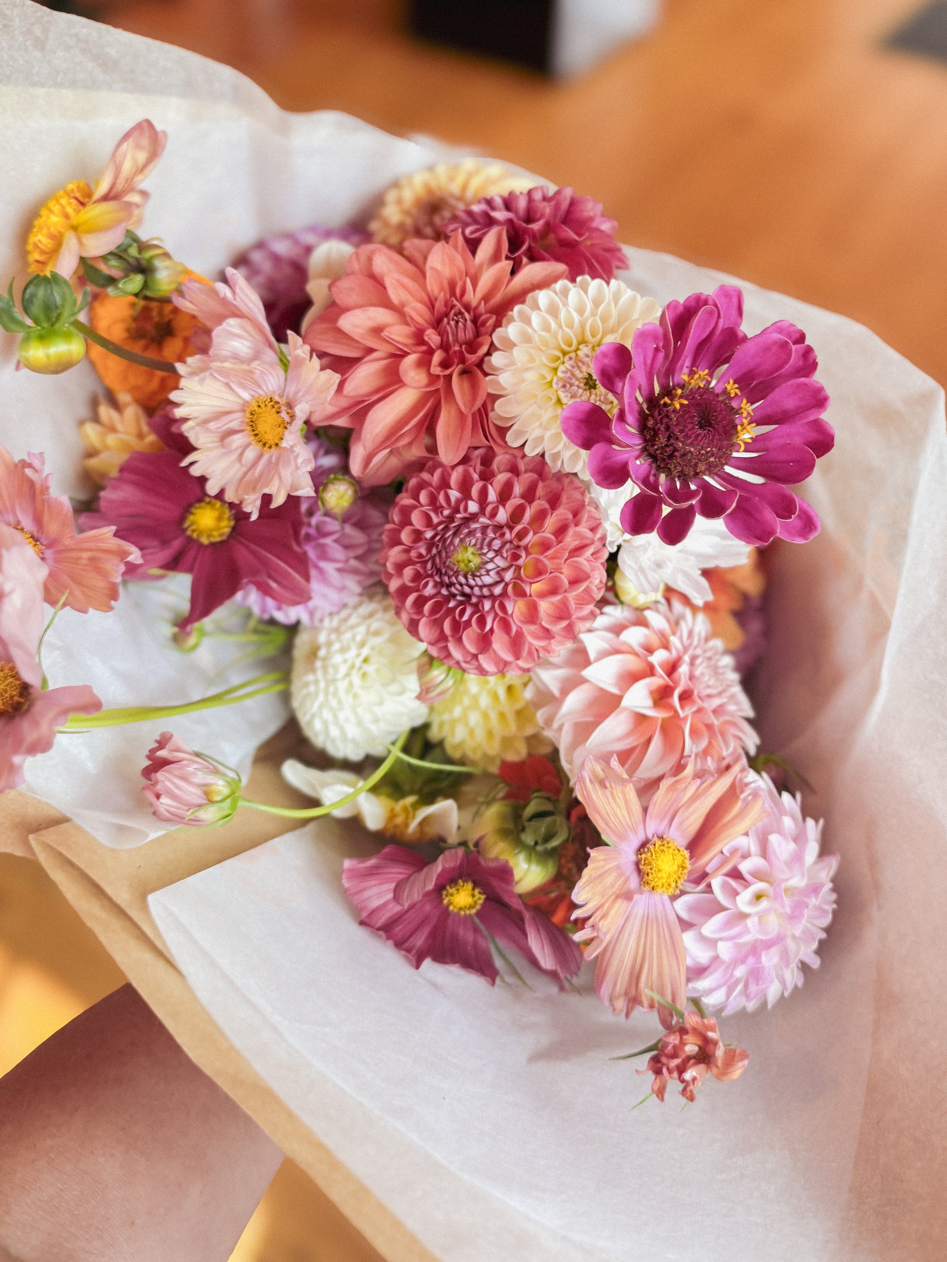 Wrapping a hand-tied bouquet at a Floral Fridays workshop